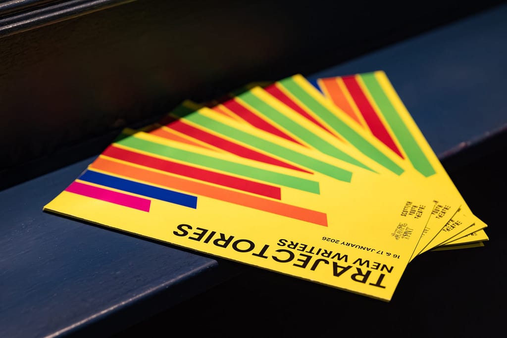 A collection of yellow pamphlets for the Trajectories final event,